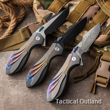 Three VG10 Damascus folding knives arranged on tactical gear
