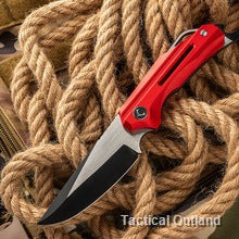 Red D2 steel folding knife opened on a rope background