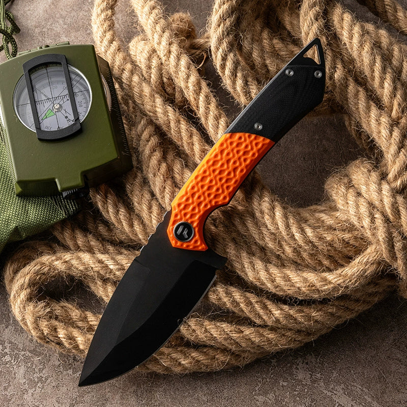 VG10 Damascus blade detail on an orange outdoor knife