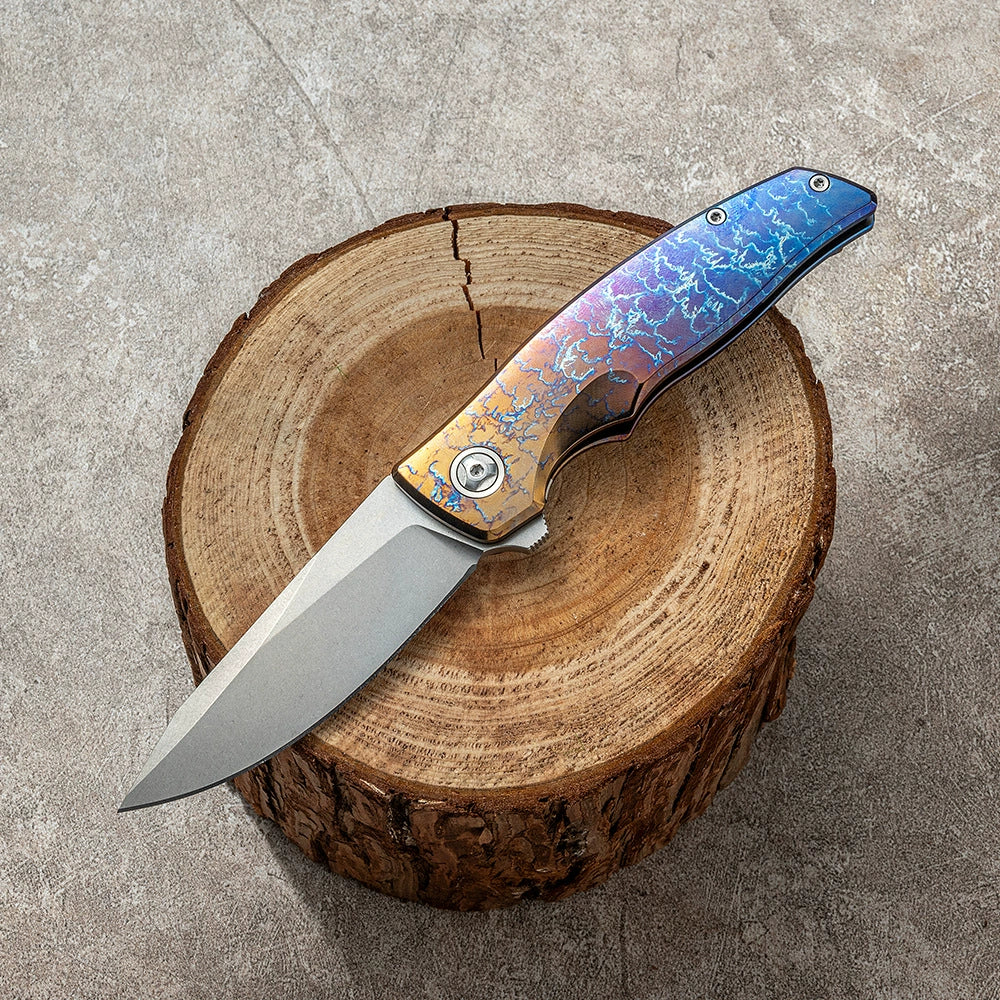 Damascus VG10 unsharpened folding knife on a wood display