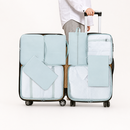 Light blue packing cubes arranged in two suitcases for organized travel