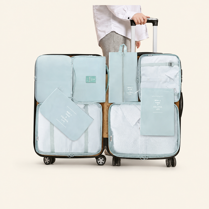 Light blue 8-piece packing cubes set arranged inside a suitcase