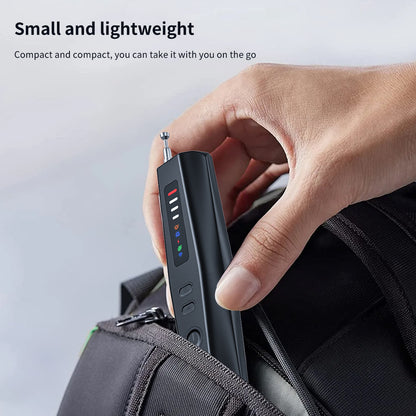 Hand putting a compact Tactical Outland anti-spy detector into a travel backpack, highlighting its lightweight and portable design.