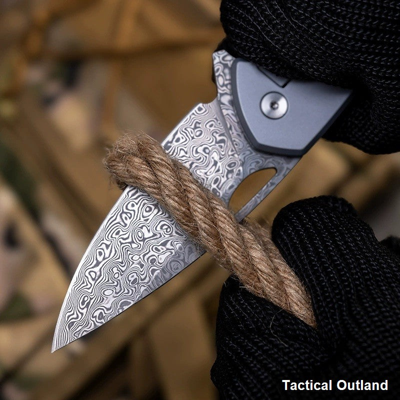 Damascus titanium carbon-fiber folding knife handle and blade detail