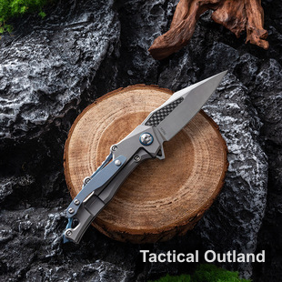 Tactical Outland VG10 titanium folding knife with sculpted alloy handle on an outdoor wood display
